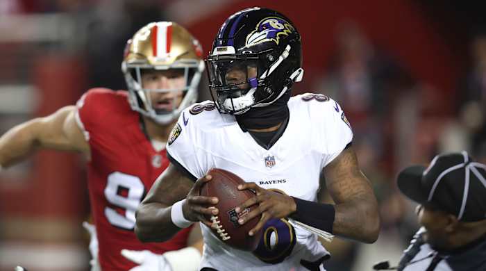 Ravens quarterback Lamar Jackson is chased by 49ers defensive end Nick Bosa